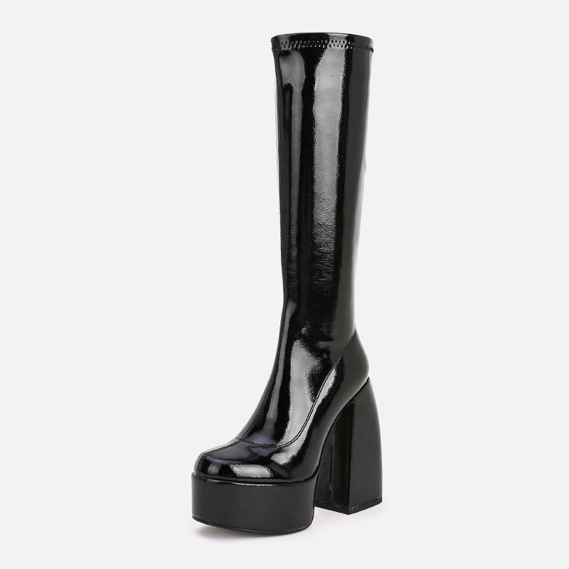 Side view of women's above-knee platform boots with chunky heel and fringe detail, alternative darkwear style