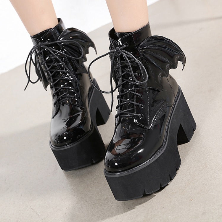 Side view of black patent leather gothic Martin boots with lace-up detail and chunky block heel