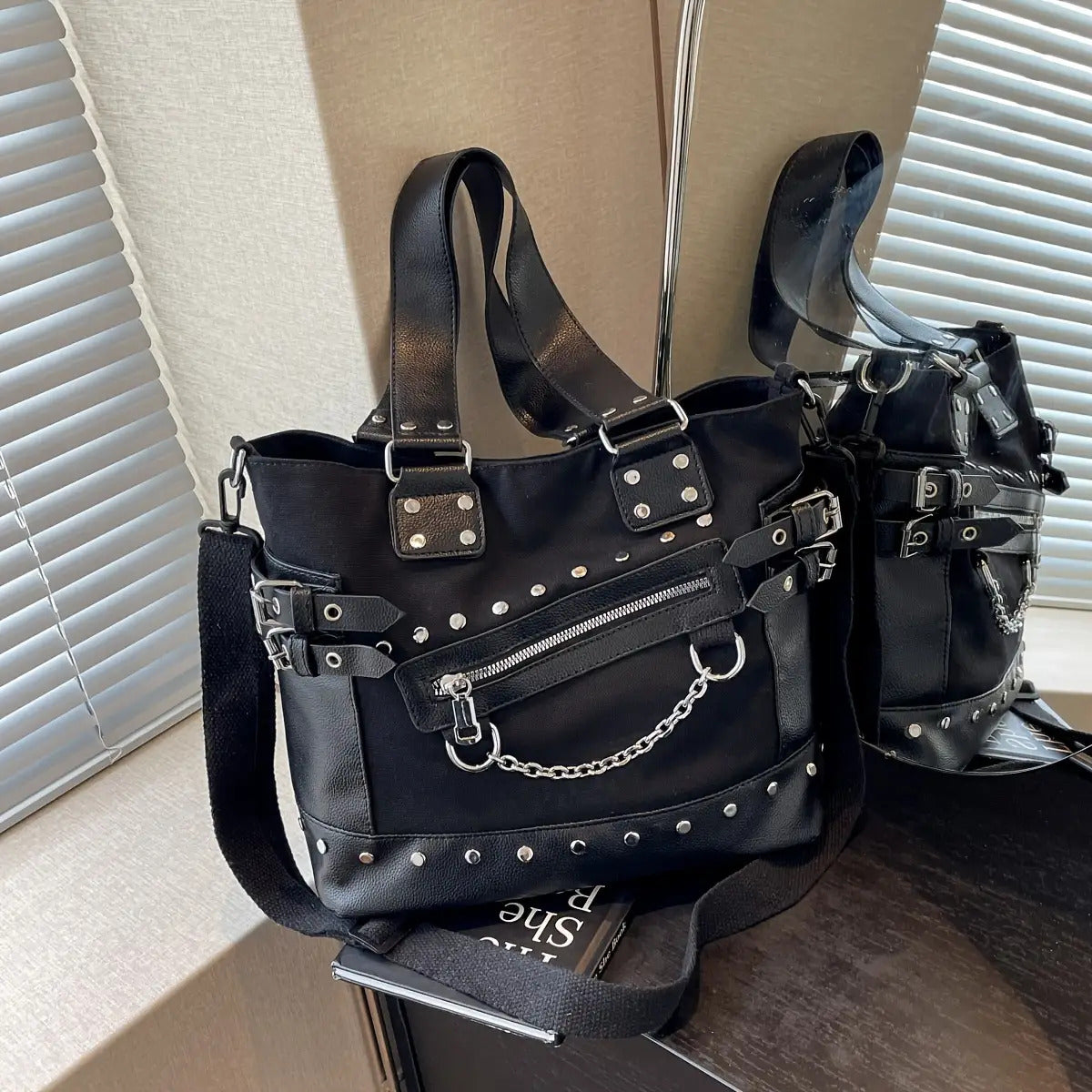 Detail view of studded tote bag showing chain hardware and rivet detailing from Alternative Darkwear