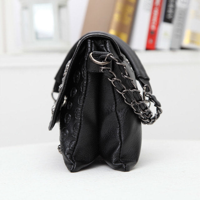 Black gothic skull emboss crossbody bag women side view chain strap gunmetal hardware PU Alternative Fashion