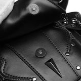 Close-up of a black leather waist bag featuring a pointed metal spike detail, silver studs, contrast stitching, and snap-button closures.
