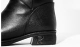 Close-up of black cowhide leather boot heel with embossed R logo detail, women's dark feminine winter boots, Alternative Darkwear