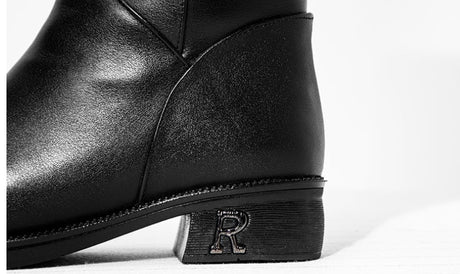 Close-up of black cowhide leather boot heel with embossed R logo detail, women's dark feminine winter boots, Alternative Darkwear