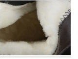 Close-up of integrated sheep fur lining inside women's black leather winter boots, warm and waterproof darkwear boots