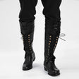 Close-up of rivet and hollow detail on men's gothic knight pirate boots in faux leather, flat rubber sole