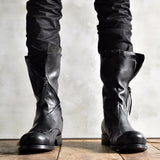 Front view of men's black deconstructed leather boots with zipper detail and round toe, standing on wooden floor, Alternative Darkwear